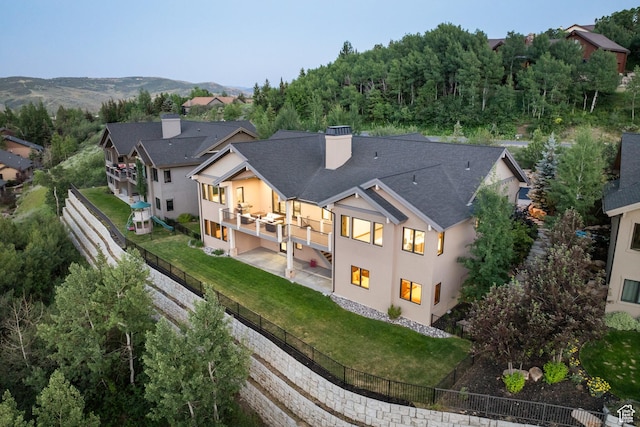 4014 W Hidden Cv Unit 11, Park City, UT 84098 - back of house featuring a fenced backyard, a patio area, a balcony, and a chimney