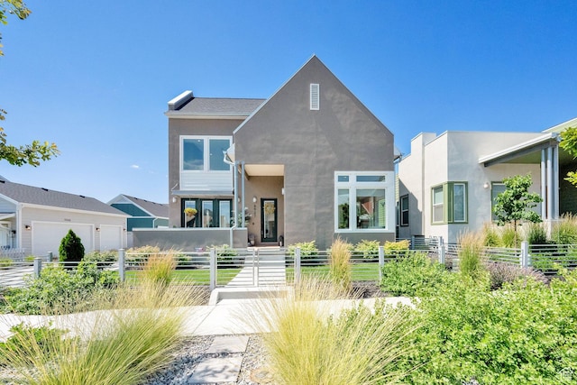 6927 W Higbrow Way S, Jordan, UT 84009 - view of front of property with stucco siding, a fenced front yard, and a garage