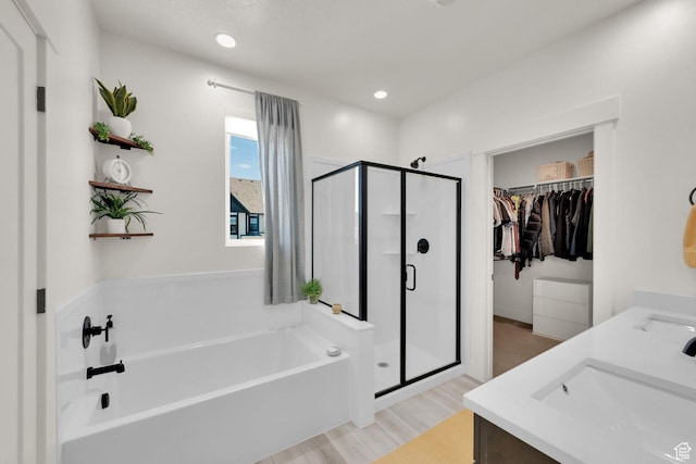 6927 W Higbrow Way S, Jordan, UT 84009 - bathroom featuring a shower stall, a bath, a spacious closet, wood finished floors, and recessed lighting