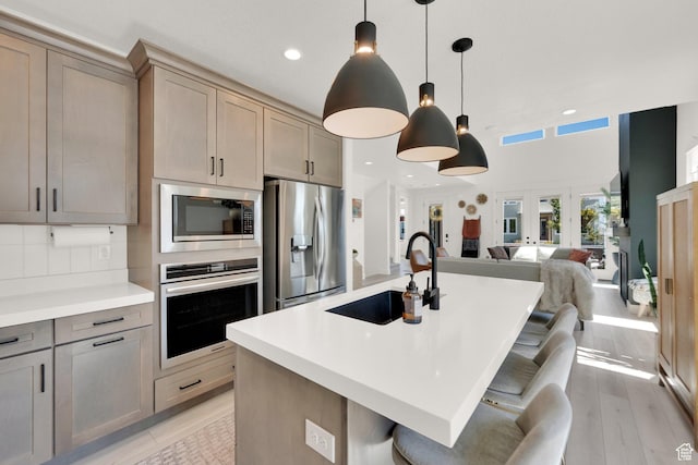 6927 W Higbrow Way S, Jordan, UT 84009 - kitchen with appliances with stainless steel finishes, open floor plan, light countertops, a center island with sink, and recessed lighting