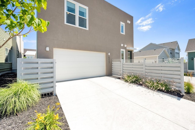 6927 W Higbrow Way S, Jordan, UT 84009 - view of side of property with an attached garage, stucco siding, and concrete driveway