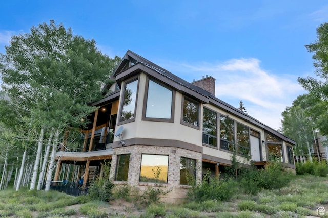 1960 N Lake Dr, Scofield, UT 84526 - rear view of property with stucco siding, a chimney, and brick siding