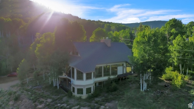 1960 N Lake Dr, Scofield, UT 84526 - back of property featuring a chimney, a wooded view, and a metal roof