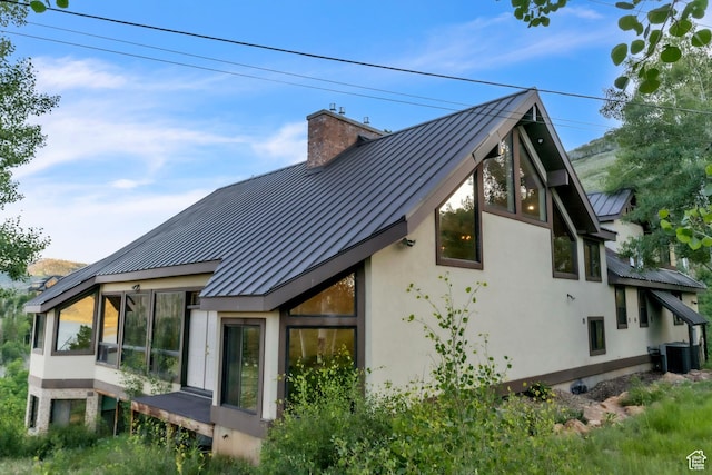 1960 N Lake Dr, Scofield, UT 84526 - view of side of property with a standing seam roof, a metal roof, stucco siding, and a chimney