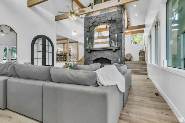 1960 N Lake Dr, Scofield, UT 84526 - living room featuring a ceiling fan, a fireplace, light wood-type flooring, french doors, and beam ceiling