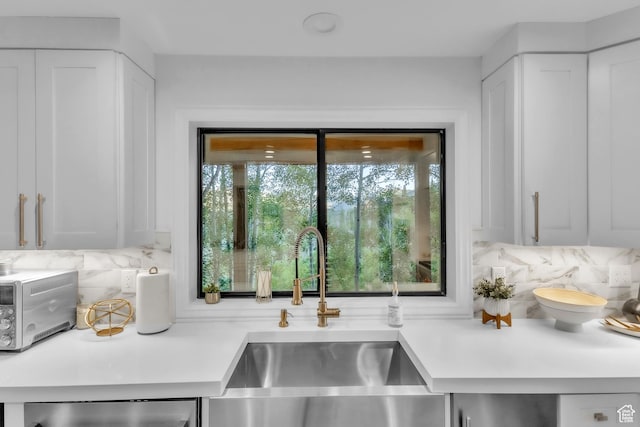 1960 N Lake Dr, Scofield, UT 84526 - kitchen with decorative backsplash, light countertops, dishwasher, and white cabinets