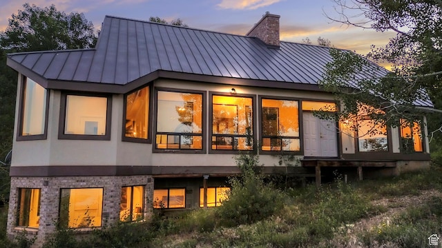 1960 N Lake Dr, Scofield, UT 84526 - rear view of property featuring a standing seam roof, stucco siding, a metal roof, and a chimney
