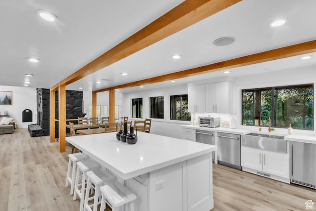 1960 N Lake Dr, Scofield, UT 84526 - kitchen featuring dishwasher, recessed lighting, white cabinets, a breakfast bar, and light wood finished floors