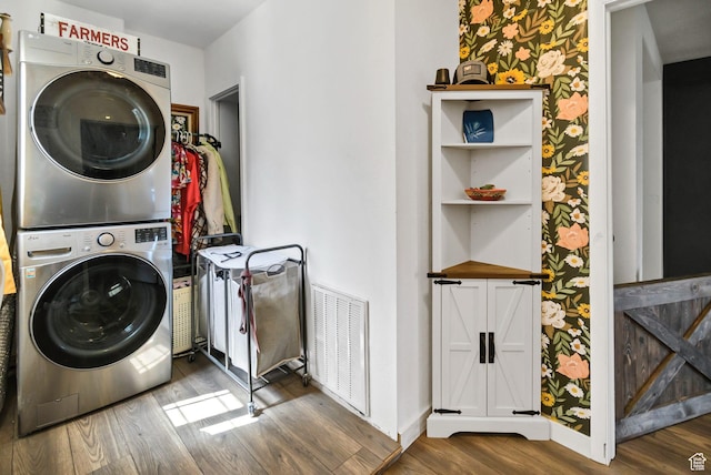 340 N Main St, Monroe, UT 84754 - washroom featuring stacked washing machine and dryer, wood finished floors, and wallpapered walls