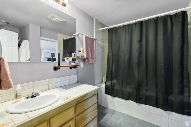 340 N Main St, Monroe, UT 84754 - bathroom with decorative backsplash, vanity, shower / bath combo, a textured ceiling, and tile patterned floors