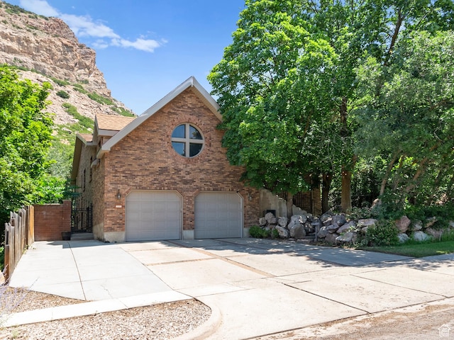 2586 S 1825 E, Ogden, UT 84401 - view of front of property with an attached garage, concrete driveway, and brick siding