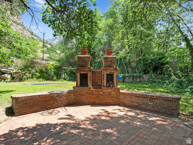 2586 S 1825 E, Ogden, UT 84401 - view of patio featuring an outdoor brick fireplace