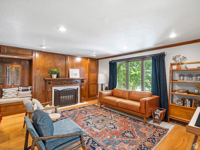 2586 S 1825 E, Ogden, UT 84401 - living area with ornamental molding, wood finished floors, a fireplace with flush hearth, a textured ceiling, and wood walls