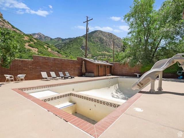 2586 S 1825 E, Ogden, UT 84401 - view of swimming pool with a water slide, a mountain view, and a patio