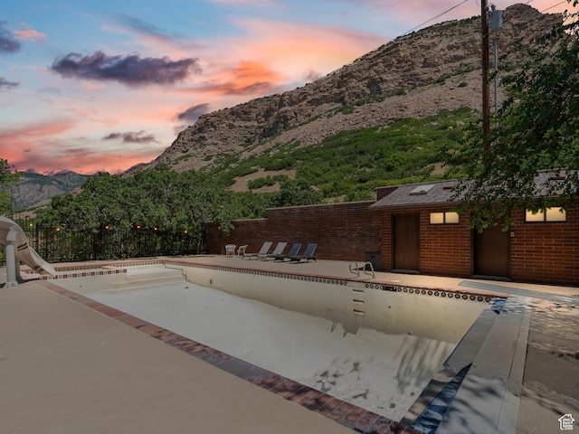 2586 S 1825 E, Ogden, UT 84401 - pool at dusk with a mountain view and a patio