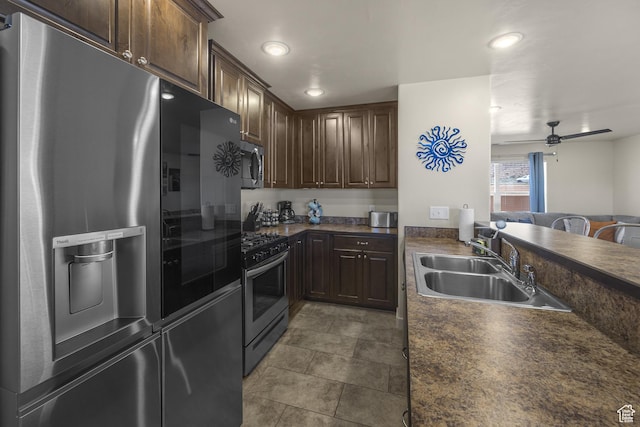 3853 Red Valley Cir Unit 22A1, Moab, UT 84532 - kitchen with appliances with stainless steel finishes, dark countertops, dark brown cabinetry, ceiling fan, and recessed lighting