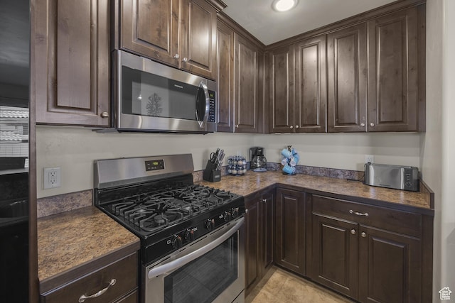 3853 Red Valley Cir Unit 22A1, Moab, UT 84532 - kitchen featuring appliances with stainless steel finishes, dark brown cabinets, and light tile patterned floors