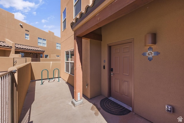 3853 Red Valley Cir Unit 22A1, Moab, UT 84532 - view of exterior entry featuring stucco siding and a balcony