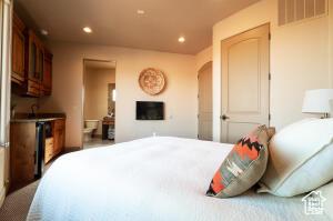 2466 W Cohonina Trl, St George, UT 84770 - bedroom with recessed lighting, arched walkways, a fireplace, and ensuite bath
