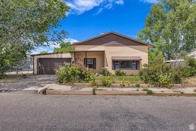 373 N 400 W, Cedar City, UT 84721 - view of front of house with driveway, a garage, and stucco siding