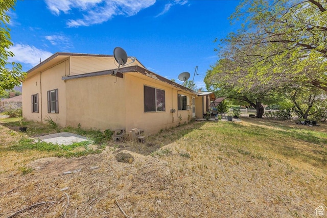 373 N 400 W, Cedar City, UT 84721 - view of home's exterior featuring stucco siding and a lawn