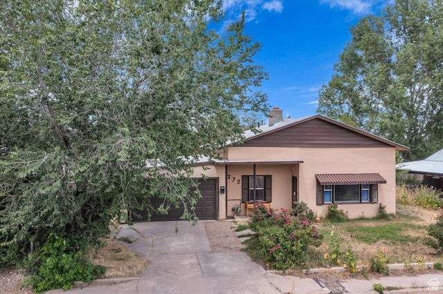 373 N 400 W, Cedar City, UT 84721 - ranch-style house with driveway, an attached garage, stucco siding, and a chimney