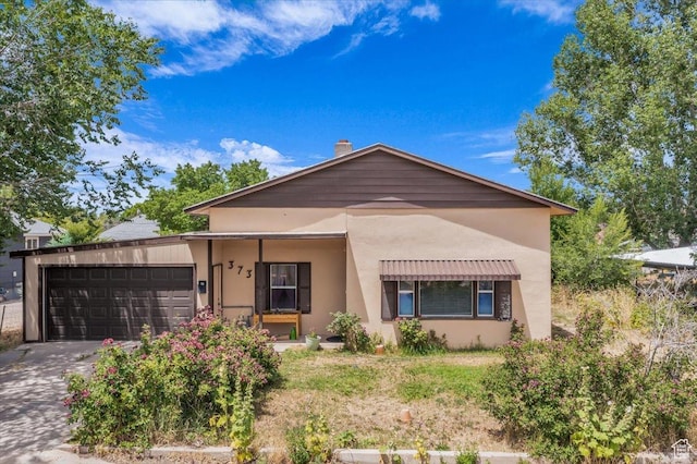 373 N 400 W, Cedar City, UT 84721 - view of front facade featuring a garage, stucco siding, and concrete driveway