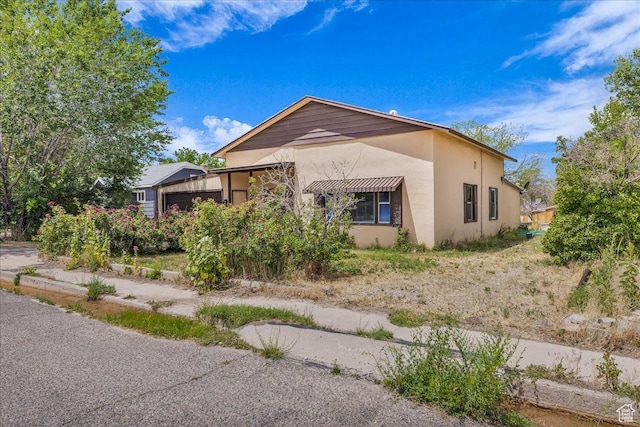 373 N 400 W, Cedar City, UT 84721 - view of home's exterior featuring stucco siding and an attached garage
