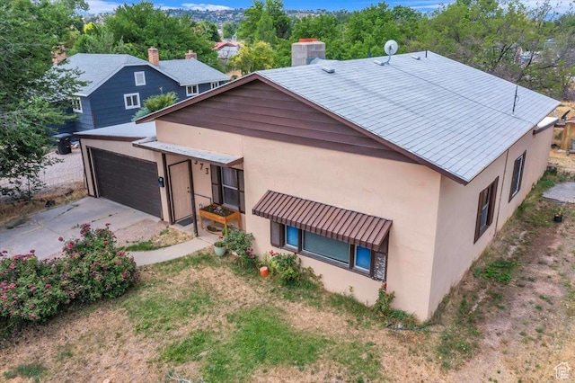 373 N 400 W, Cedar City, UT 84721 - back of house featuring stucco siding, concrete driveway, a chimney, and an attached garage
