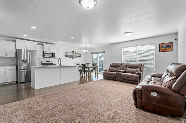 14907 S Messi St, Herriman, UT 84096 - living area featuring dark wood-style floors, a chandelier, recessed lighting, and a textured ceiling
