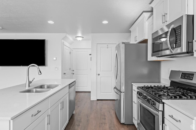 14907 S Messi St, Herriman, UT 84096 - kitchen featuring appliances with stainless steel finishes, white cabinetry, light countertops, dark wood-style floors, and recessed lighting