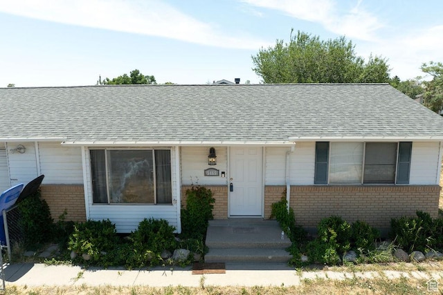 5465 W 5400 S, Kearns, UT 84118 - view of front of home featuring brick siding and roof with shingles