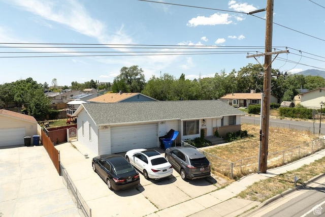 5465 W 5400 S, Kearns, UT 84118 - ranch-style house with a garage, driveway, roof with shingles, and a residential view