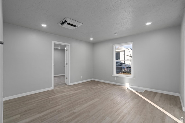 3174 S 9100 W, Magna, UT 84044 - spare room featuring recessed lighting, a textured ceiling, and wood finished floors
