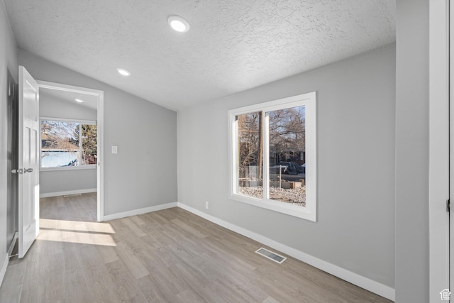 3174 S 9100 W, Magna, UT 84044 - unfurnished bedroom with a textured ceiling, vaulted ceiling, wood finished floors, and recessed lighting