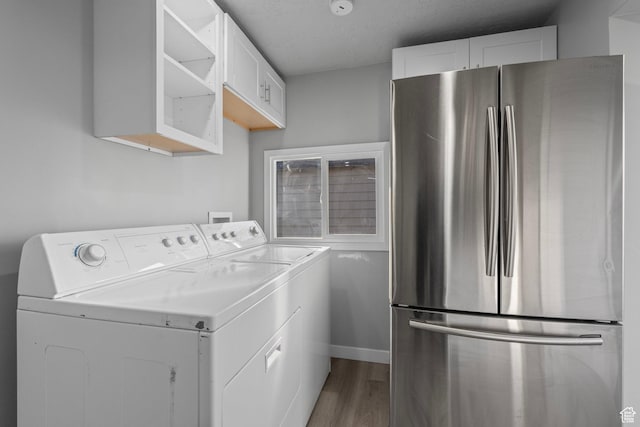 3174 S 9100 W, Magna, UT 84044 - laundry room with washing machine and clothes dryer, wood finished floors, and a textured ceiling