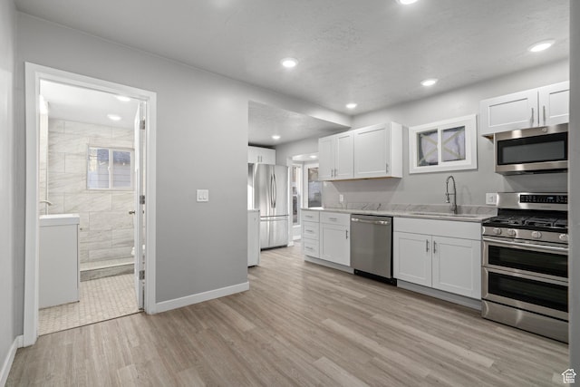 3174 S 9100 W, Magna, UT 84044 - kitchen with stainless steel appliances, light wood-style floors, white cabinets, recessed lighting, and light stone counters