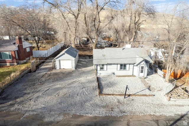 3174 S 9100 W, Magna, UT 84044 - view of front of house with an outbuilding, a detached garage, and gravel driveway
