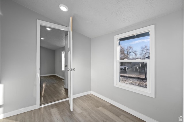 3174 S 9100 W, Magna, UT 84044 - unfurnished bedroom featuring wood finished floors, a textured ceiling, and recessed lighting