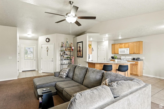 253 N 4300 W, Cedar City, UT 84720 - living room featuring light tile patterned flooring, a textured ceiling, a ceiling fan, and vaulted ceiling