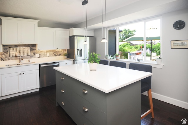 2845 Banbury Rd E, Cottonwood Heights, UT 84121 - kitchen featuring appliances with stainless steel finishes, tasteful backsplash, white cabinetry, dark wood-style flooring, and light countertops