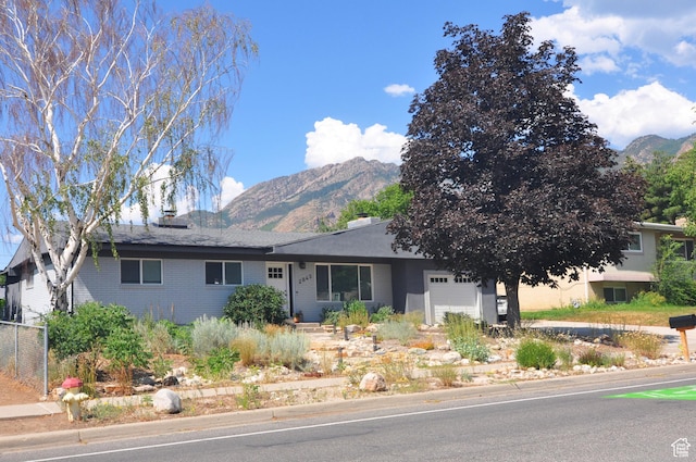 2845 Banbury Rd E, Cottonwood Heights, UT 84121 - ranch-style home featuring a mountain view, a garage, brick siding, and a chimney