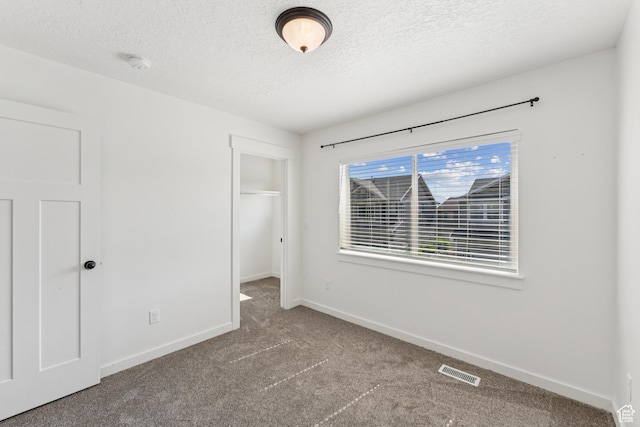 13316 S Moseley Way, Herriman, UT 84096 - unfurnished bedroom featuring carpet floors, a textured ceiling, a spacious closet, and a closet