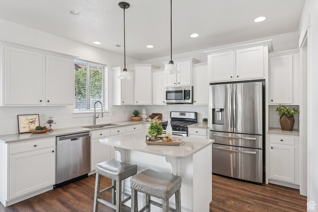 13316 S Moseley Way, Herriman, UT 84096 - kitchen featuring stainless steel appliances, white cabinets, light countertops, dark wood-style flooring, and a breakfast bar area