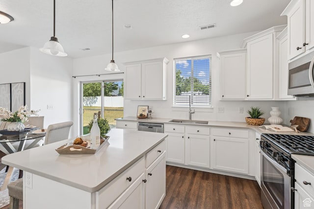 13316 S Moseley Way, Herriman, UT 84096 - kitchen featuring stainless steel appliances, dark wood-type flooring, light countertops, white cabinetry, and recessed lighting