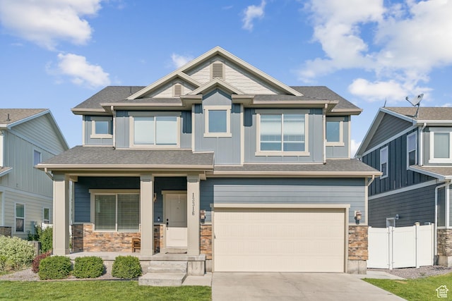 13316 S Moseley Way, Herriman, UT 84096 - view of front of home featuring an attached garage, concrete driveway, covered porch, and stone siding