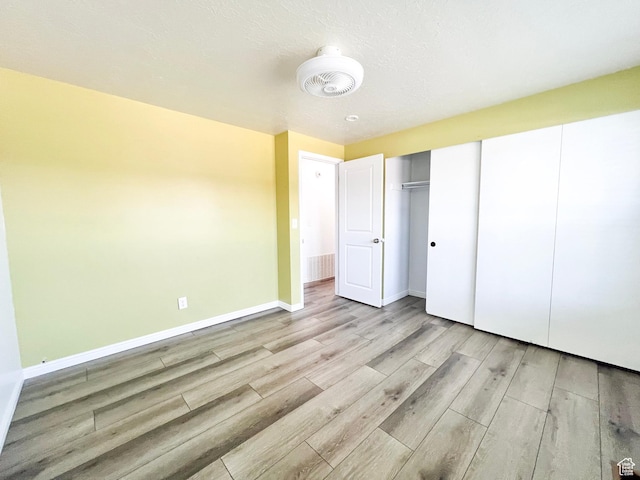 2072 W 5075 S, Roy, UT 84067 - unfurnished bedroom featuring wood finished floors and a closet