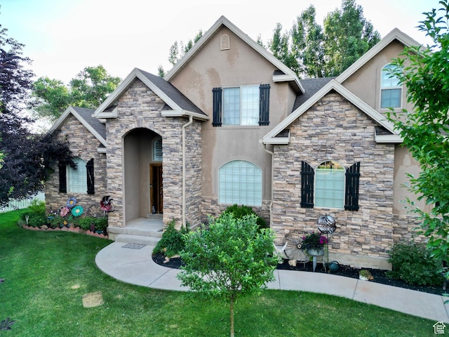 23 S 2200 W, Roosevelt, UT 84066 - view of front of property with stone siding, stucco siding, and a front lawn