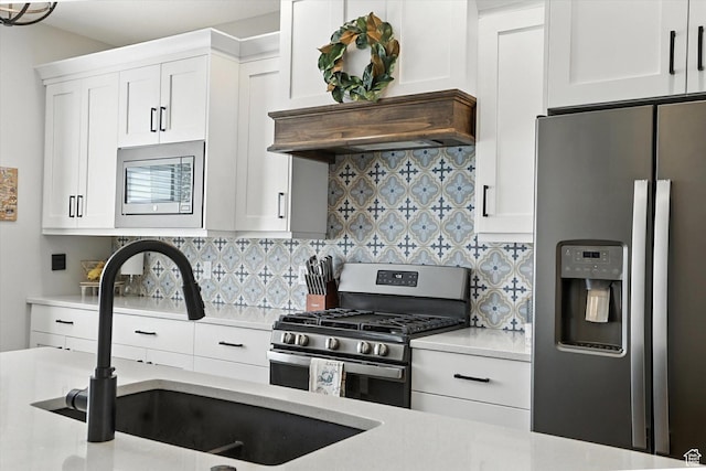 4781 N Selma Way, Erda, UT 84074 - kitchen featuring stainless steel appliances, light countertops, backsplash, and white cabinets
