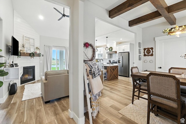 4781 N Selma Way, Erda, UT 84074 - living room with a ceiling fan, light wood finished floors, beam ceiling, a fireplace, and recessed lighting